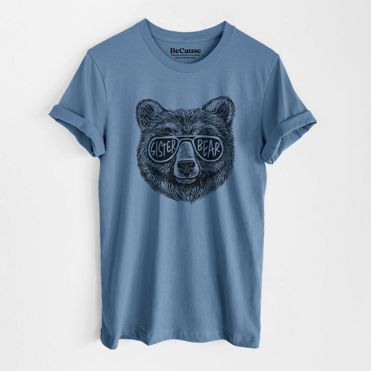 Steel blue lightweight cotton t-shirt laid flat, printed with a black ink bear's face wearing sunglasses that read Sister Bear.