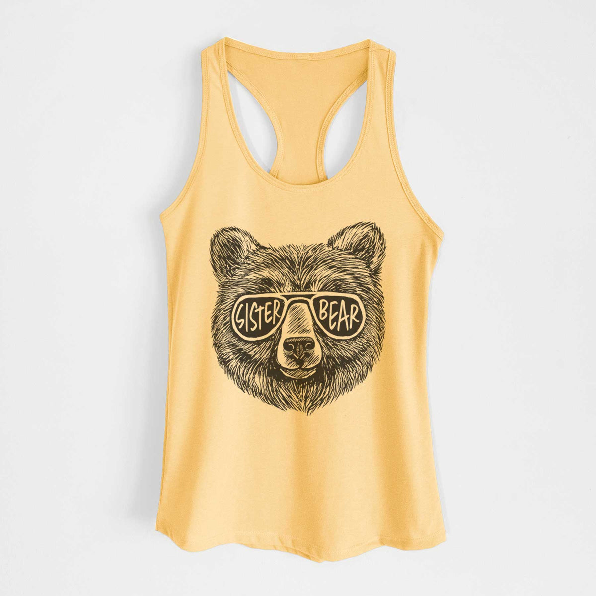 Banana cream women's racerback tank top laid flat, printed with a black ink bear's face wearing sunglasses that read Sister Bear.
