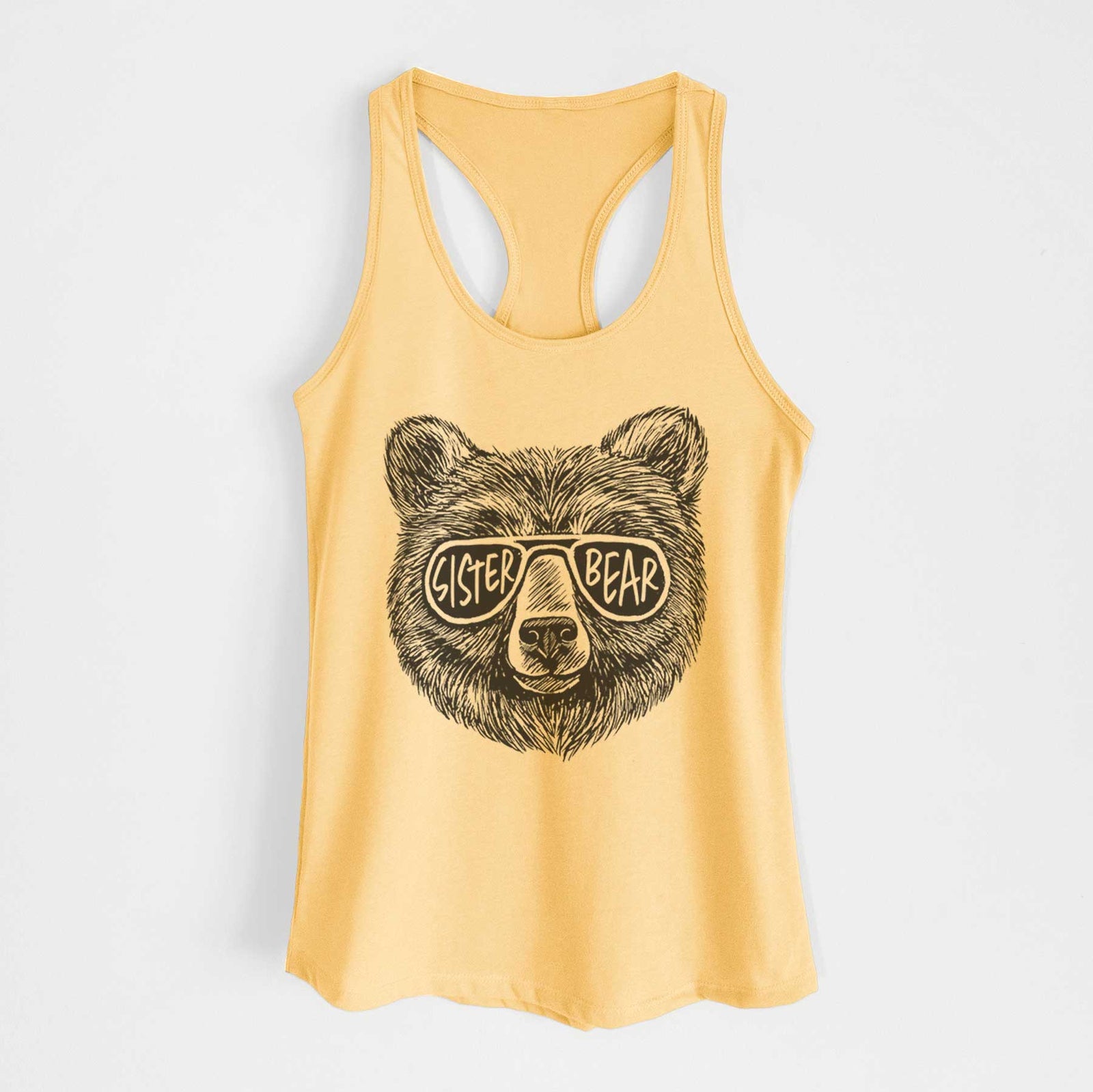Banana cream women's racerback tank top laid flat, printed with a black ink bear's face wearing sunglasses that read Sister Bear.