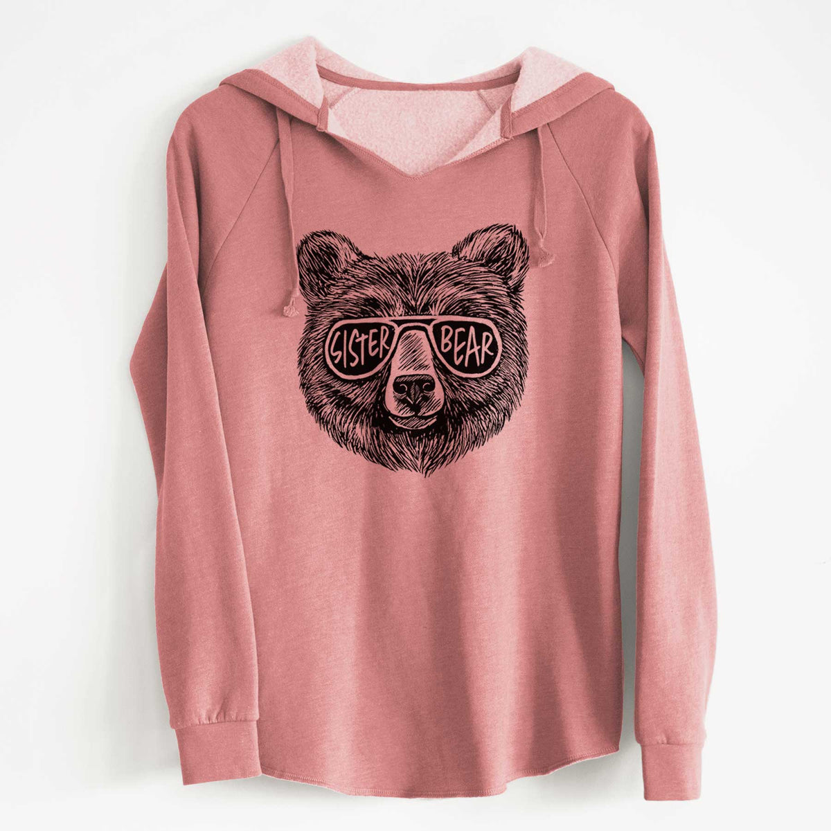 Dusty rose women's Cali Wave hooded sweatshirt laid flat, printed with a black ink bear's face wearing sunglasses that read Sister Bear.