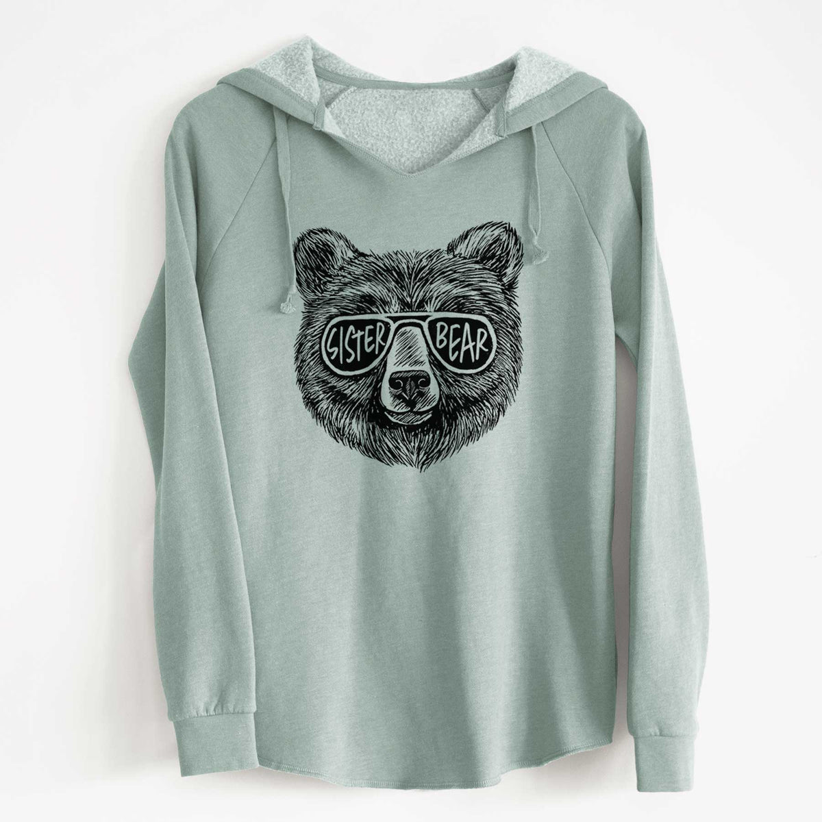 Sage green women's Cali Wave hooded sweatshirt laid flat, printed with a black ink bear's face wearing sunglasses that read Sister Bear.