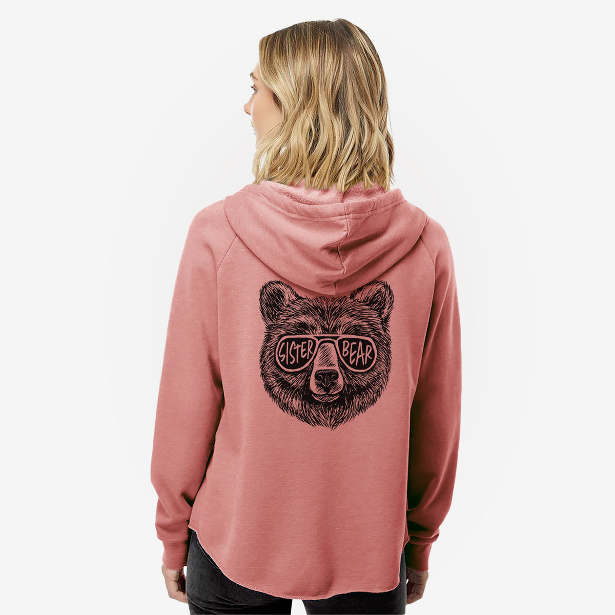 Woman wearing a dusty rose women's Cali Wave zip-up sweatshirt printed with a black ink bear's face wearing sunglasses that read Sister Bear, seen from behind.