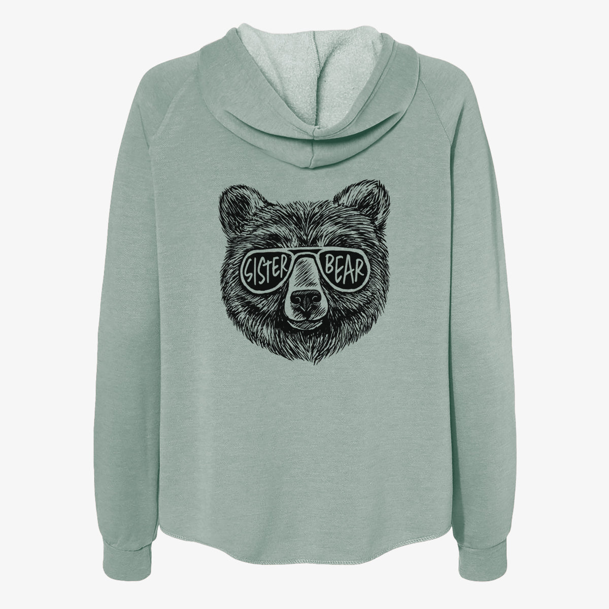 Sage green women's Cali Wave zip-up sweatshirt laid flat, printed with a black ink bear's face wearing sunglasses that read Sister Bear.