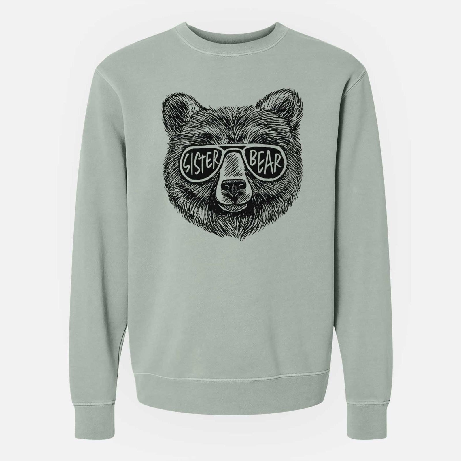 Sage green pigment dyed crewneck sweatshirt laid flat, printed with a black ink bear's face wearing sunglasses that read Sister Bear.