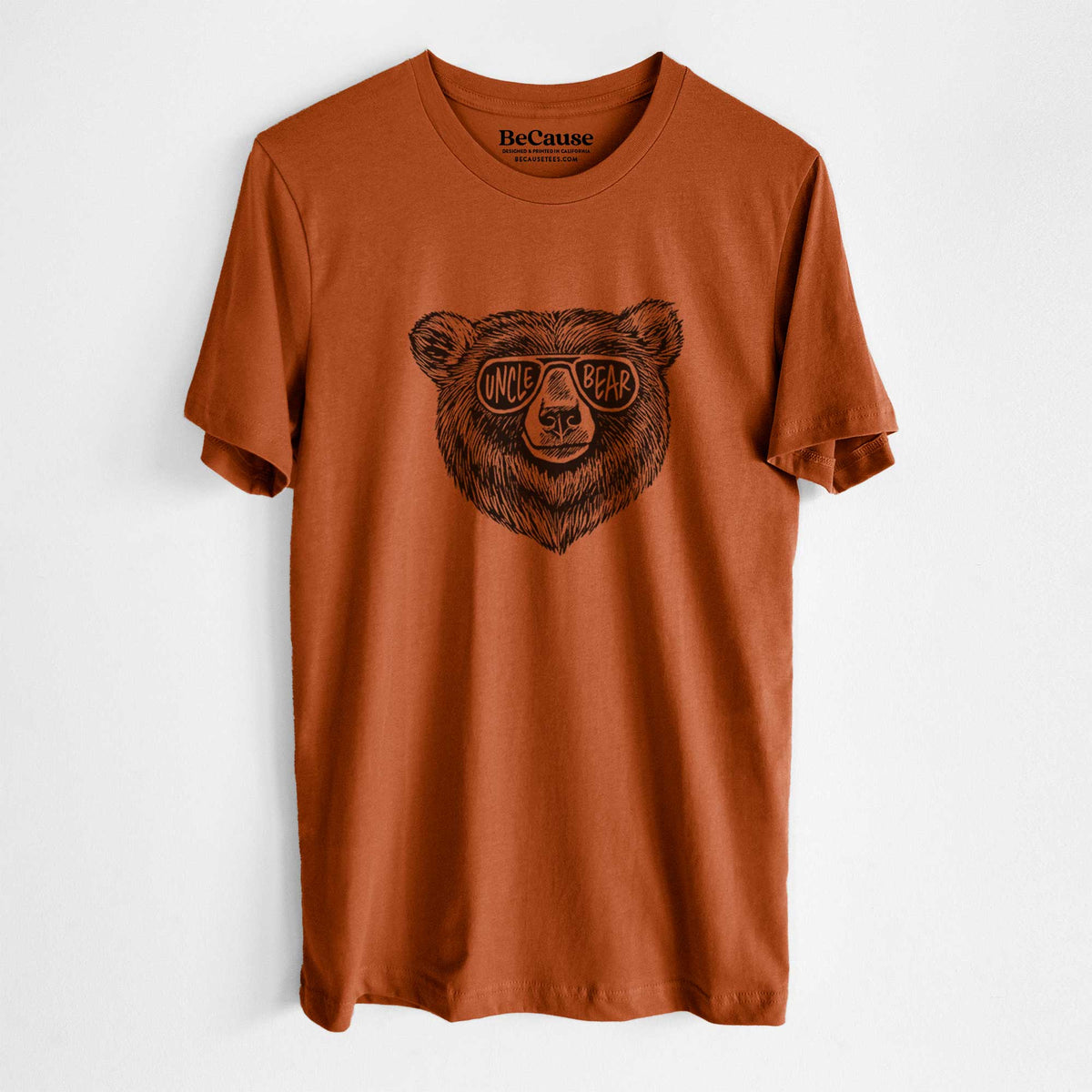 Autumn lightweight cotton t-shirt laid flat, printed with a black ink bear's face wearing sunglasses that read Uncle Bear.
