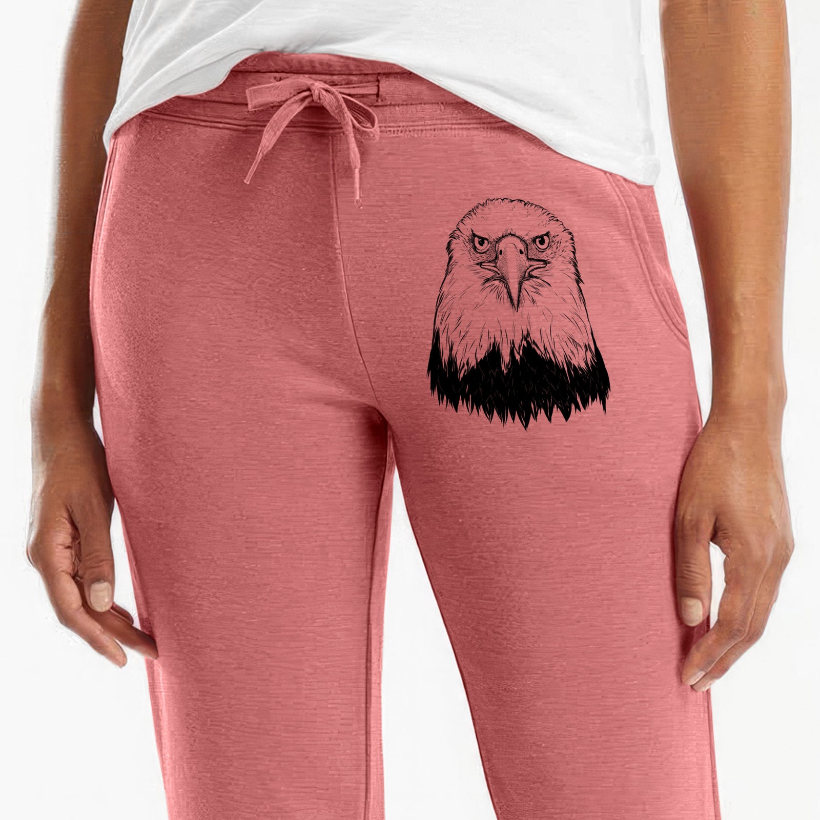 Front of dusty rose Cali Wave sweatpants, printed with a detailed black ink portrait of a bald eagle facing forward on the leg.