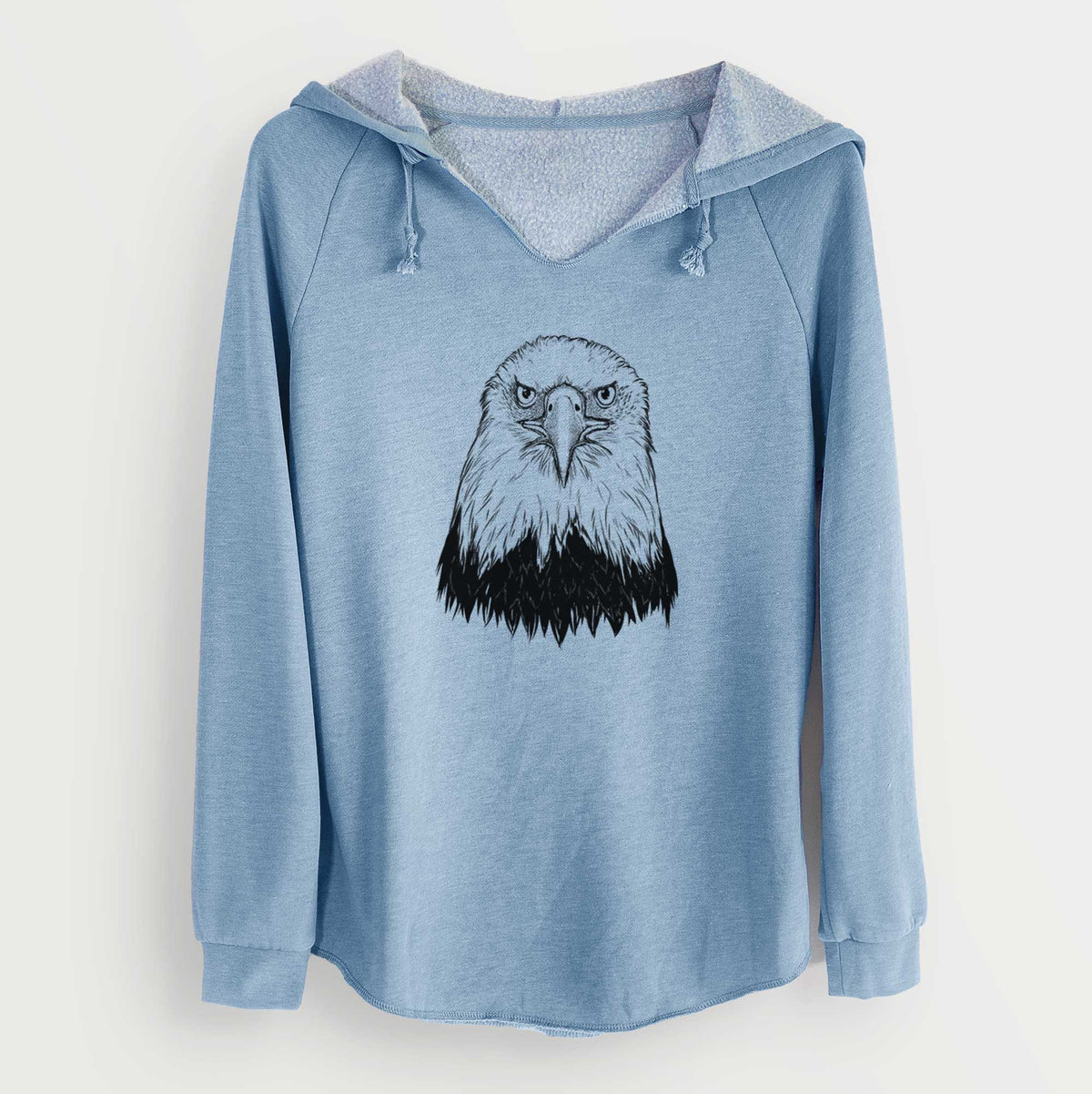 Misty blue women's Cali Wave hooded sweatshirt laid flat, printed with a detailed black ink portrait of a bald eagle facing forward.