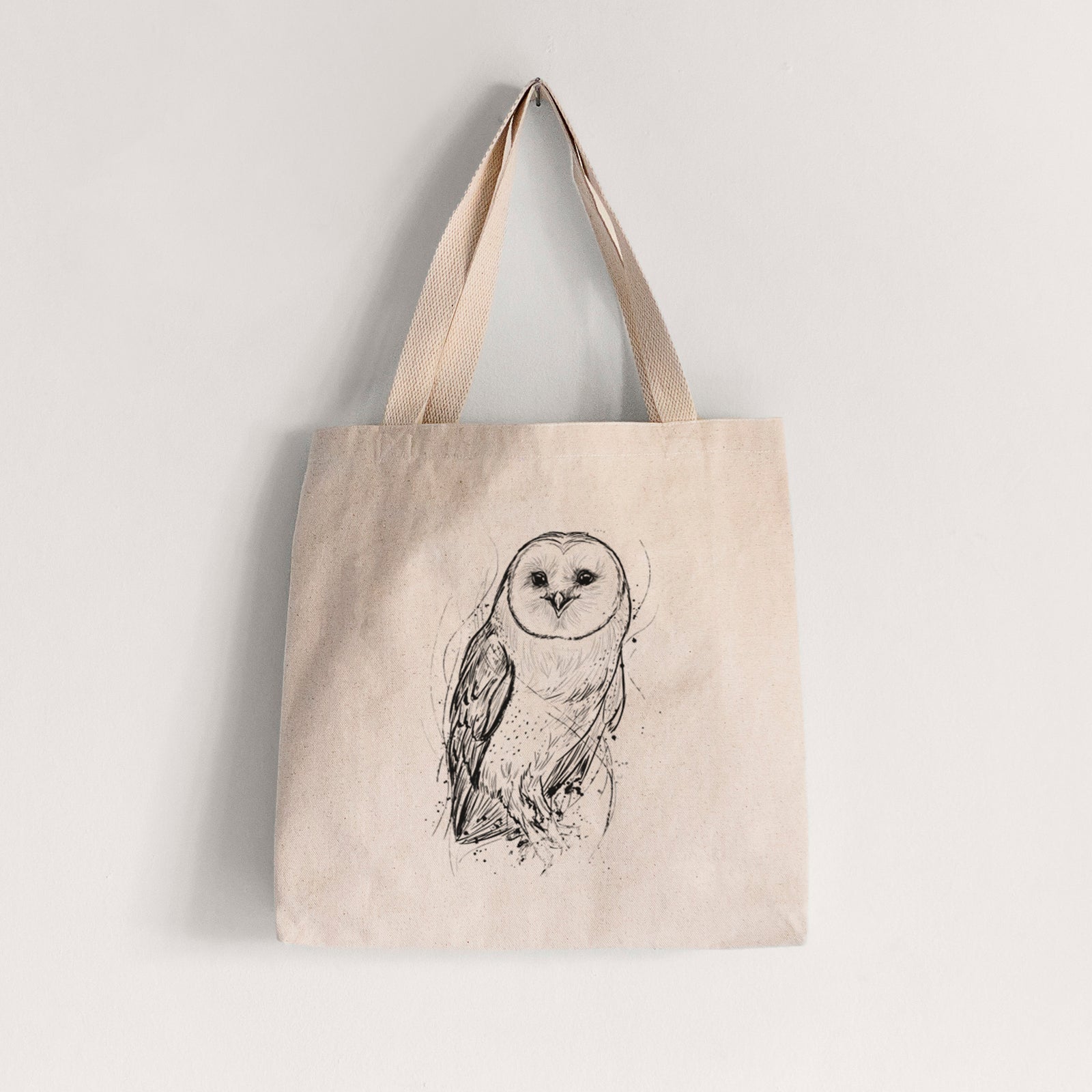 Natural canvas tote bag printed with a detailed black ink illustration of a barn owl standing and facing forward.