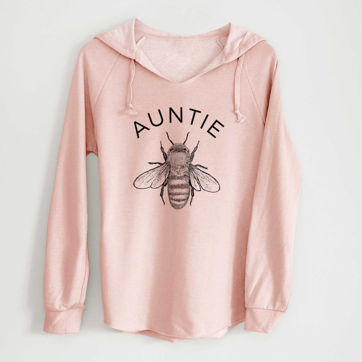 Blush pink women's Cali Wave hooded sweatshirt laid flat, printed with a black ink honey bee beneath the word Auntie.