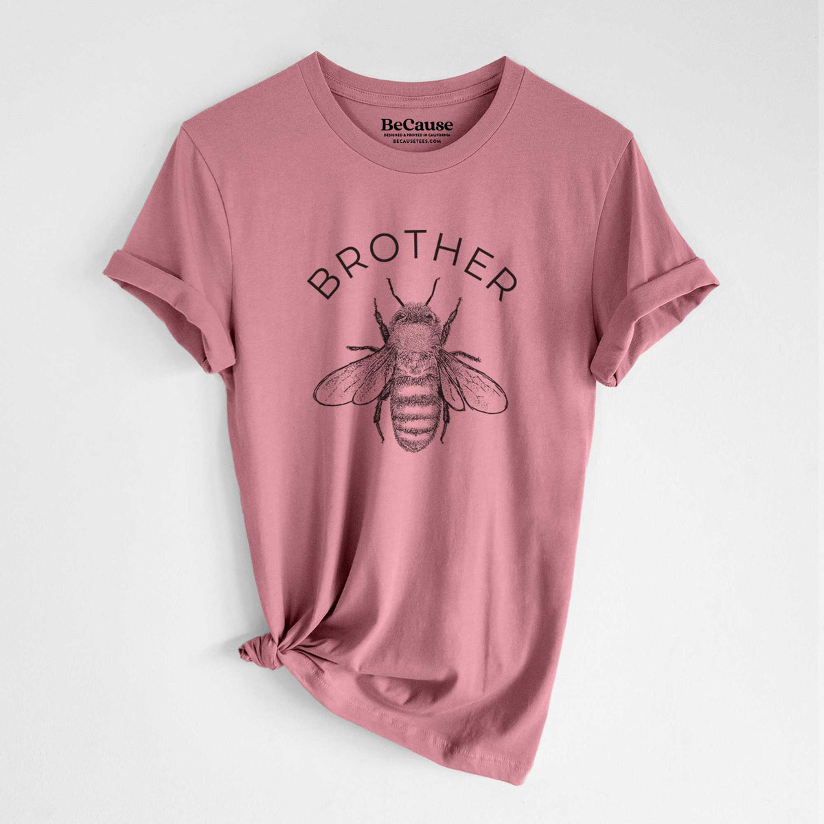 Mauve pink lightweight cotton t-shirt laid flat with the sleeves rolled, printed with a black ink honey bee beneath the word Brother.