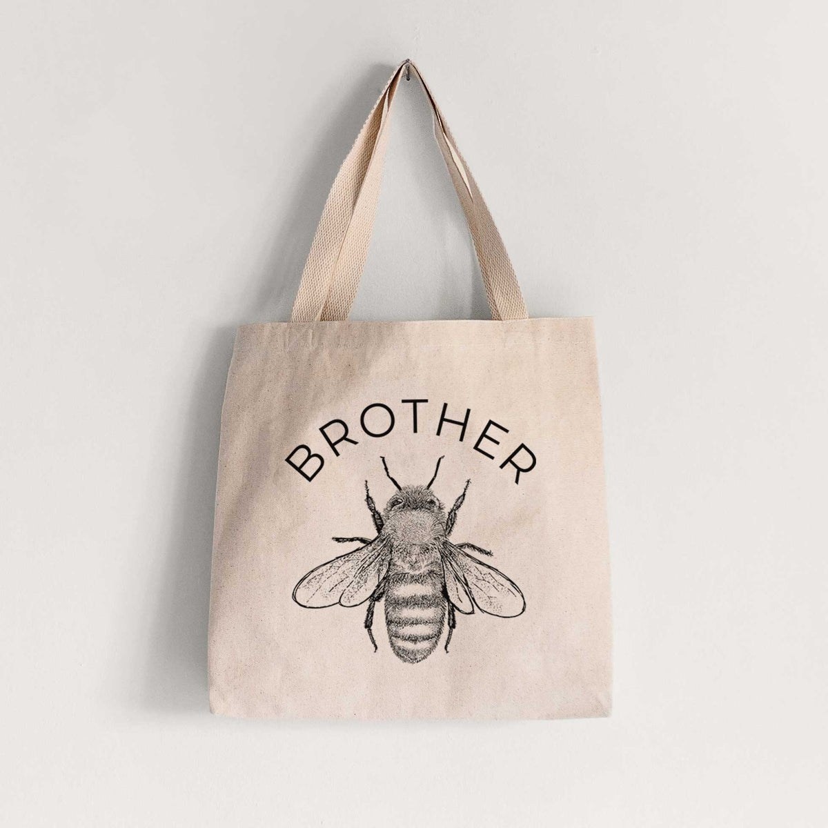 Natural canvas tote bag printed with a black ink honey bee beneath the word Brother.