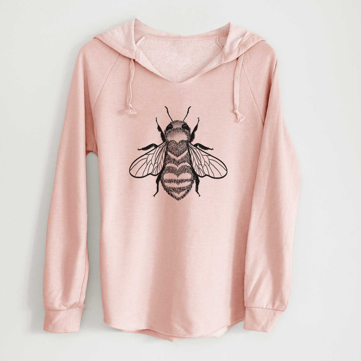 Blush pink women's Cali Wave hooded sweatshirt laid flat, printed with a black ink bee with a heart pattern on its body.