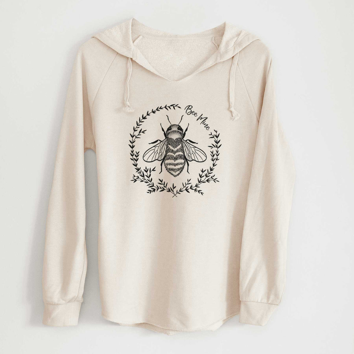 Bone cream women's Cali Wave hooded sweatshirt laid flat, printed with a black ink bee inside a wreath of leaves with the words Bee Mine.