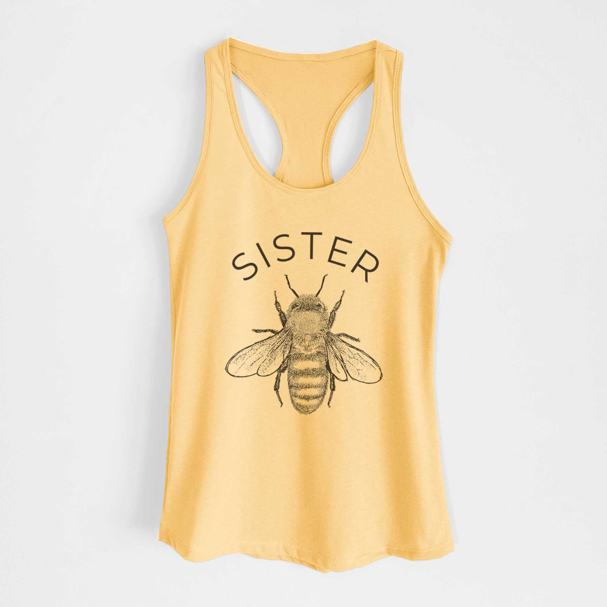 Banana cream women's racerback tank top laid flat, printed with a black ink honey bee beneath the word Sister.