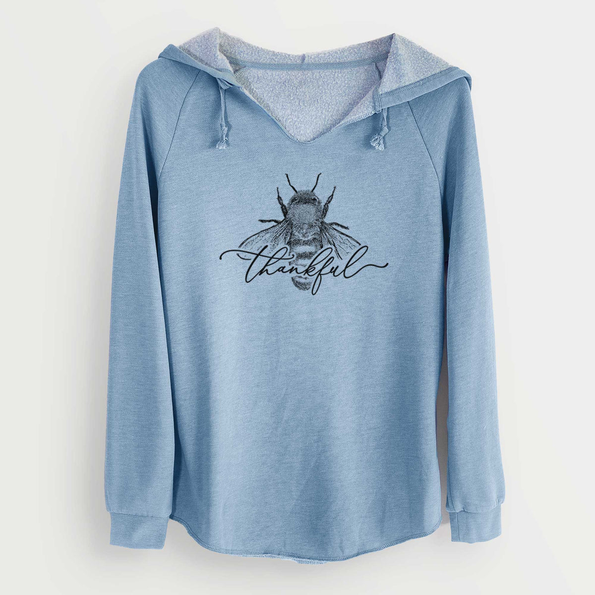 Misty blue women's Cali Wave hooded sweatshirt laid flat, printed with a black ink bee with the word thankful written in script across it.