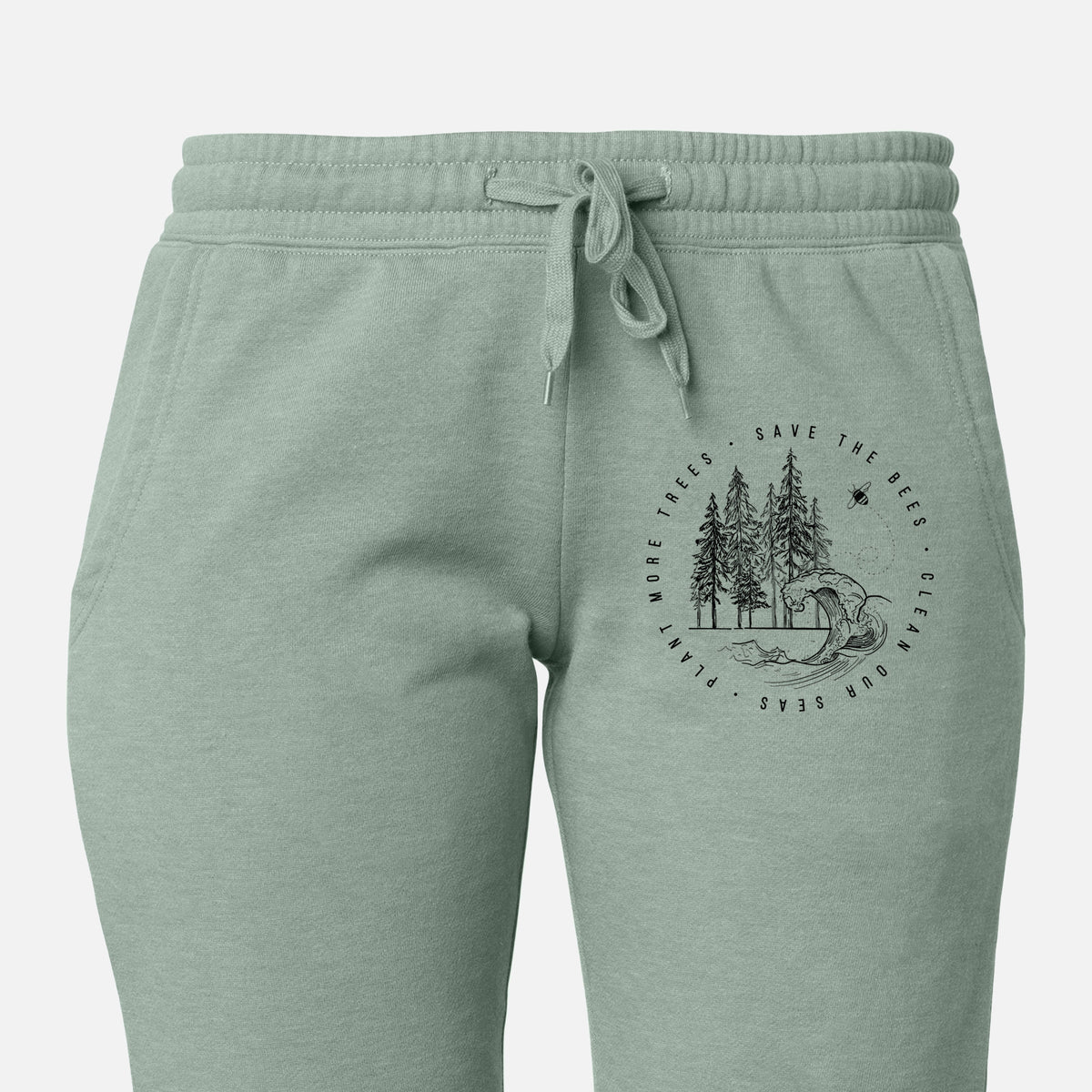 Front of sage green Cali Wave sweatpants, printed with a circle of pine trees and an ocean wave ringed by the words Save the Bees, Clean Our Seas, Plant More Trees on the leg.
