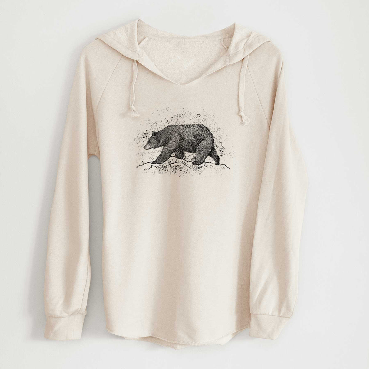 Bone cream women's Cali Wave hooded sweatshirt laid flat, printed with a detailed black ink sketch of a black bear walking across rocky ground.