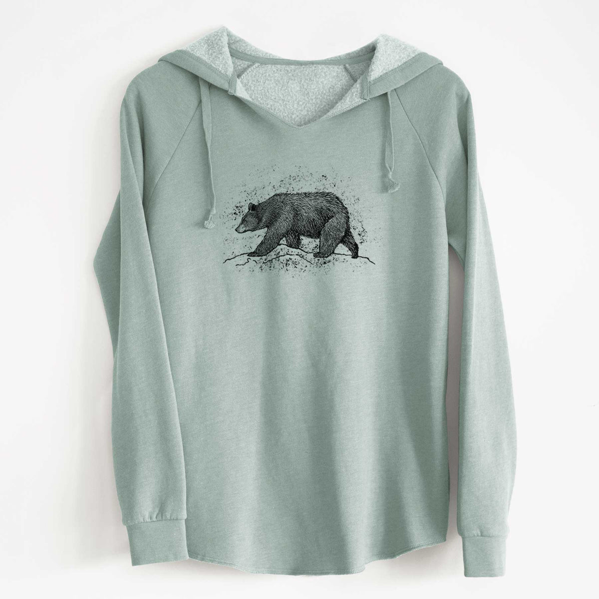 Sage green women's Cali Wave hooded sweatshirt laid flat, printed with a detailed black ink sketch of a black bear walking across rocky ground.