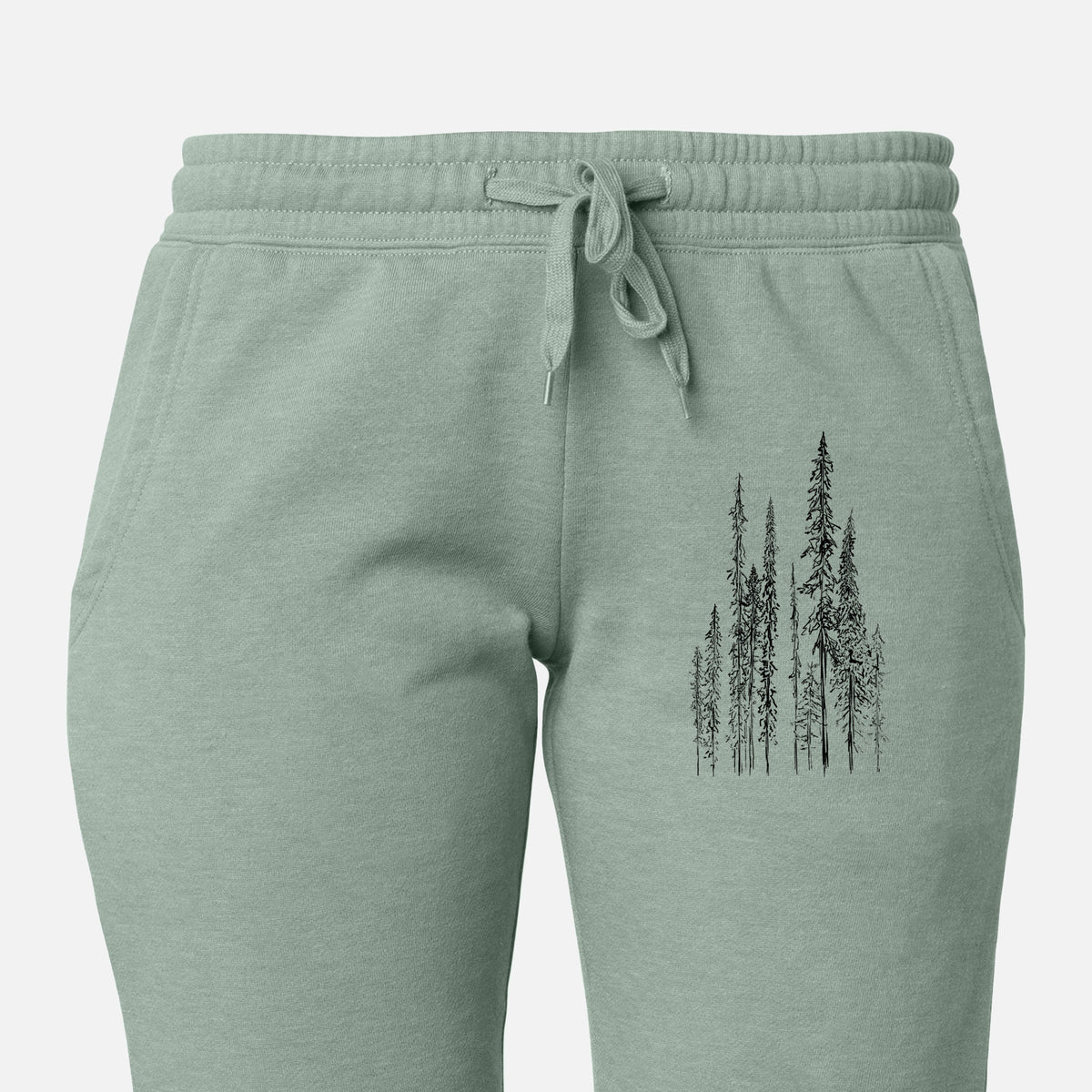 Front of sage green Cali Wave sweatpants, printed with a black ink illustration of a stand of tall, narrow black spruce trees on the leg.