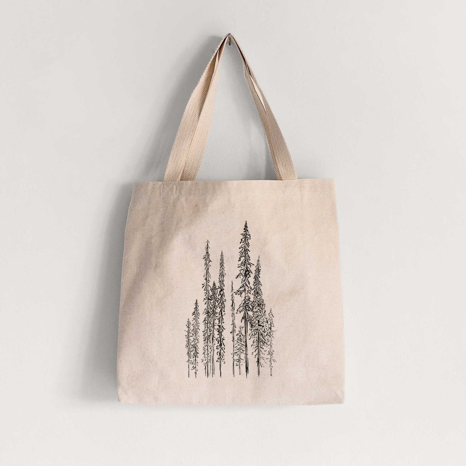 Natural canvas tote bag printed with a black ink illustration of a stand of tall, narrow black spruce trees.