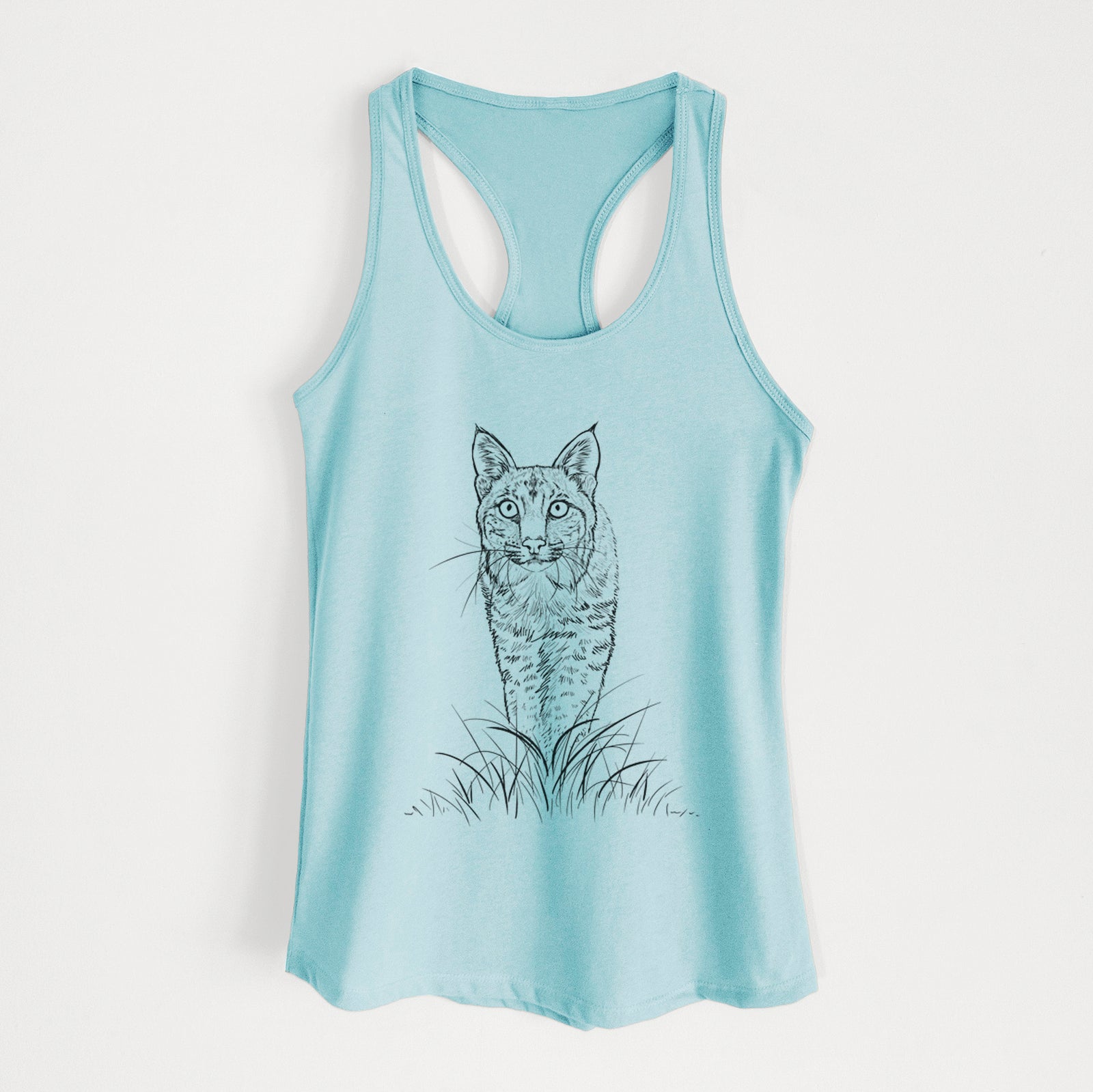 Banana cream women's racerback tank top laid flat, printed with a black ink illustration of a bobcat standing in tall grass, facing forward.