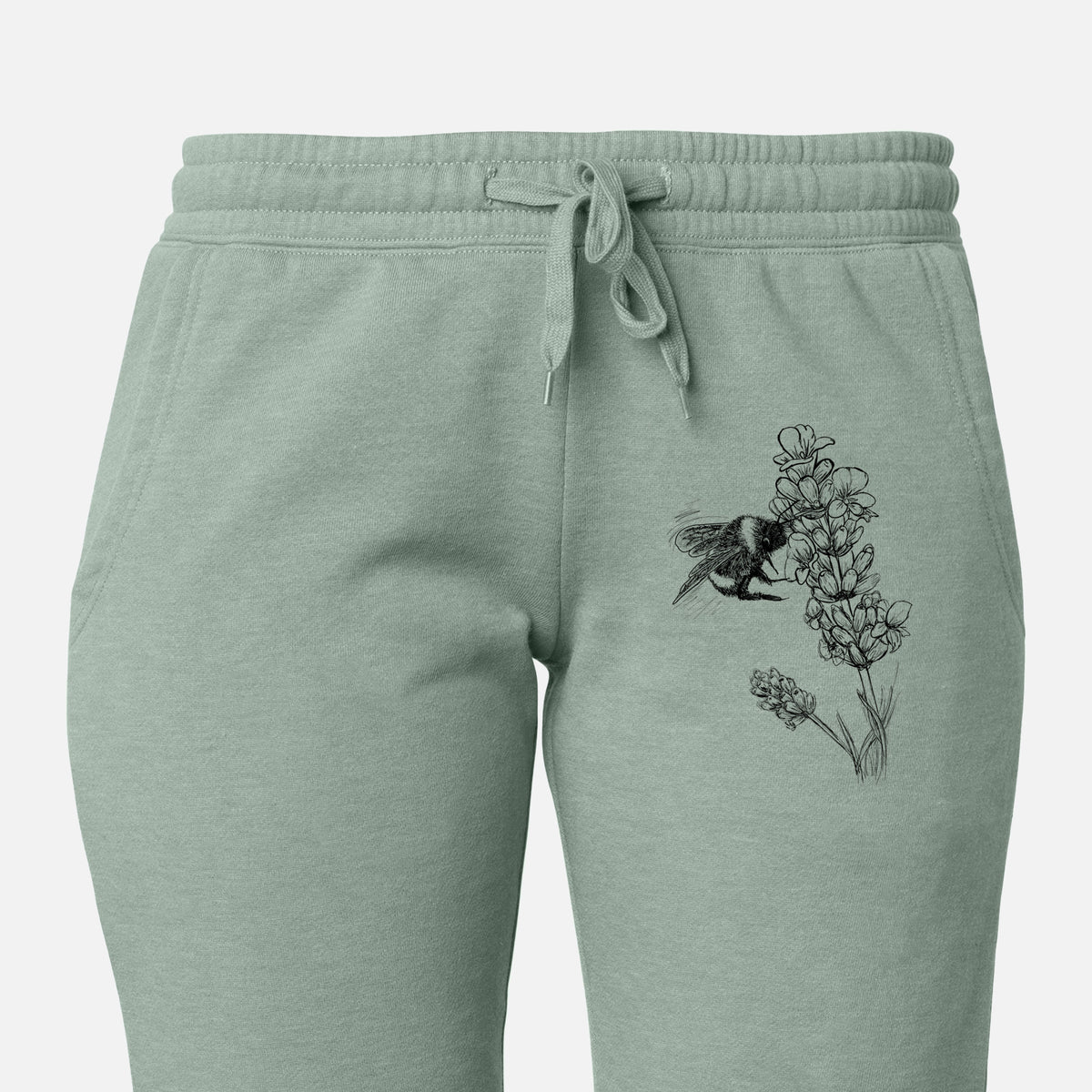 Front of sage green Cali Wave sweatpants, printed with a black ink illustration of a bumble bee visiting a sprig of lavender on the leg.