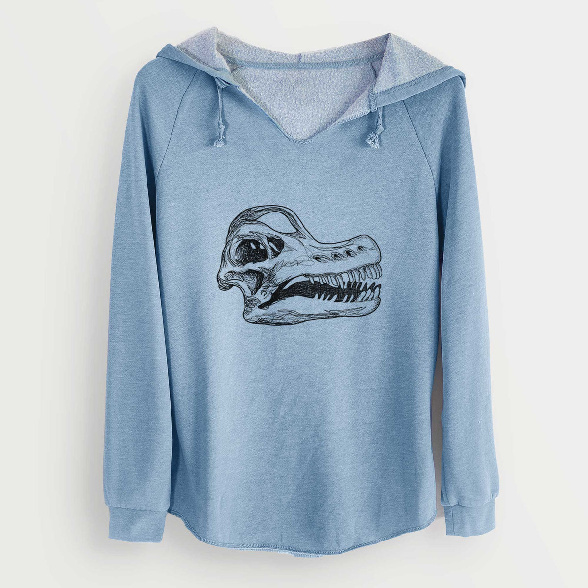 Misty blue women's Cali Wave hooded sweatshirt laid flat, printed with a detailed black ink illustration of a Brachiosaurus skull.
