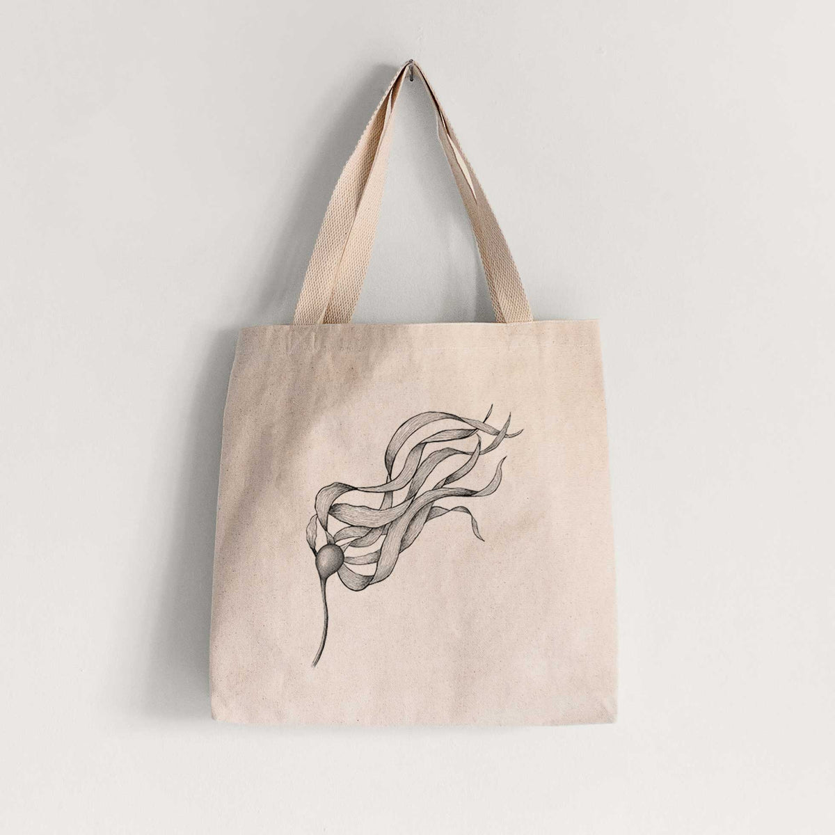 Natural canvas tote bag printed with a black ink line drawing of a strand of bull kelp with long flowing blades.