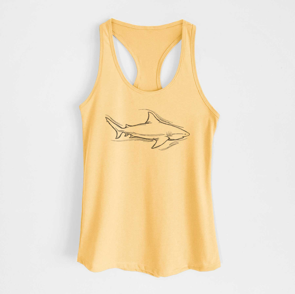 Banana cream women's racerback tank top laid flat, printed with a black ink illustration of a bull shark swimming.