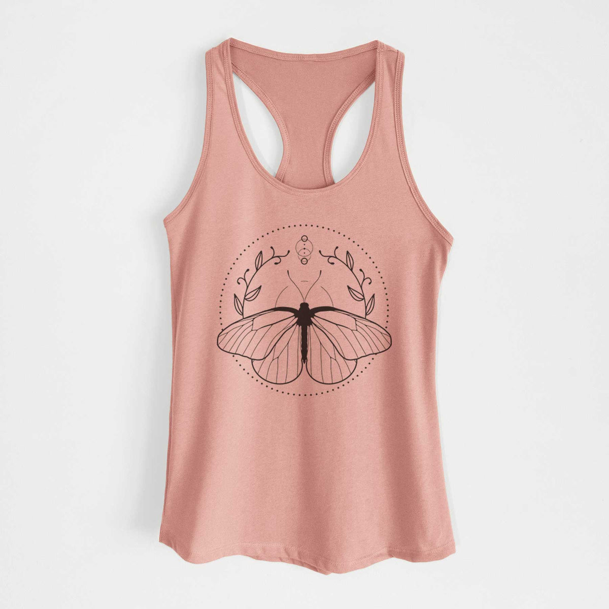 Desert pink women's racerback tank top laid flat, printed with a black ink butterfly inside a circle, framed by moon phases and leaves.