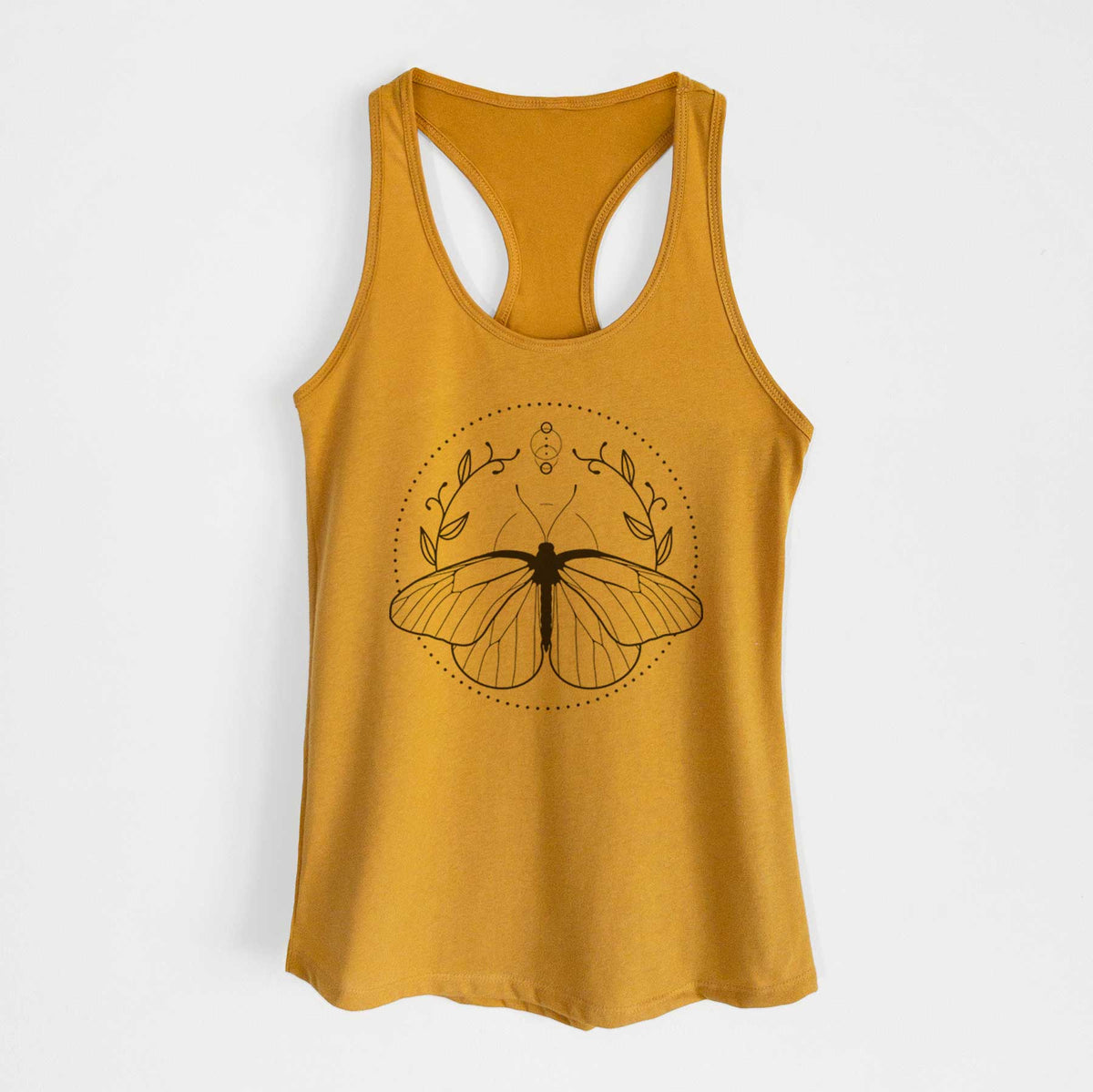 Gold women's racerback tank top laid flat, printed with a black ink butterfly inside a circle, framed by moon phases and leaves.