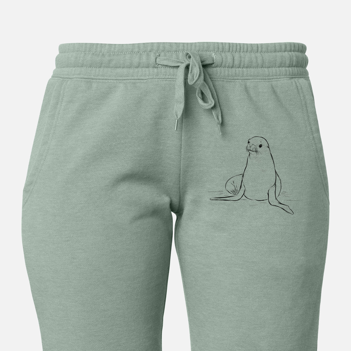 Front of sage green Cali Wave sweatpants, printed with a black ink illustration of a California sea lion sitting upright on the leg.