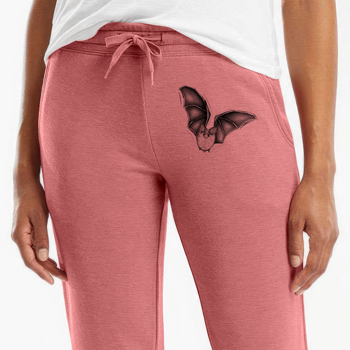 Front of dusty rose Cali Wave sweatpants, printed with a detailed black ink illustration of a California leaf-nosed bat in flight on the leg.