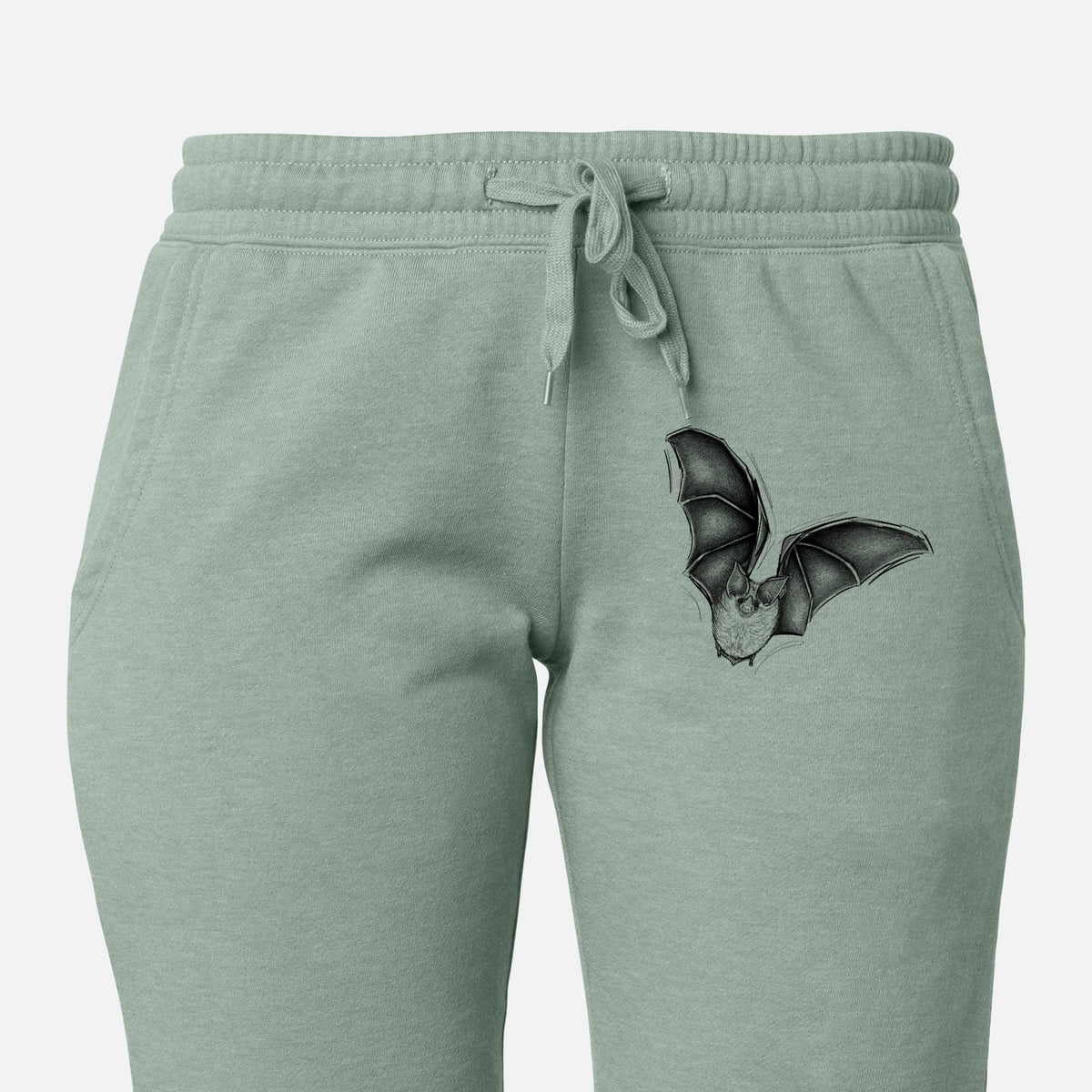 Front of sage green Cali Wave sweatpants, printed with a detailed black ink illustration of a California leaf-nosed bat in flight on the leg.