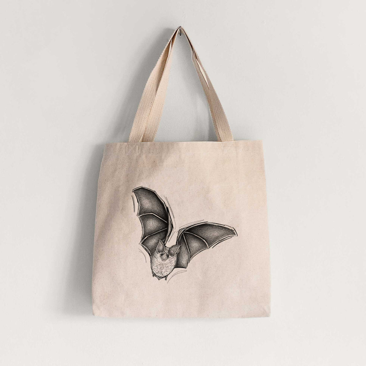 Natural canvas tote bag printed with a detailed black ink illustration of a California leaf-nosed bat in flight.