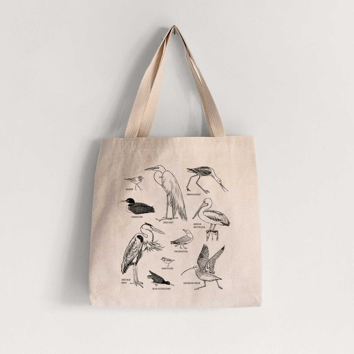 Natural canvas tote bag printed with a chart of black ink California shorebirds, including herons, egrets, avocets and sandpipers.