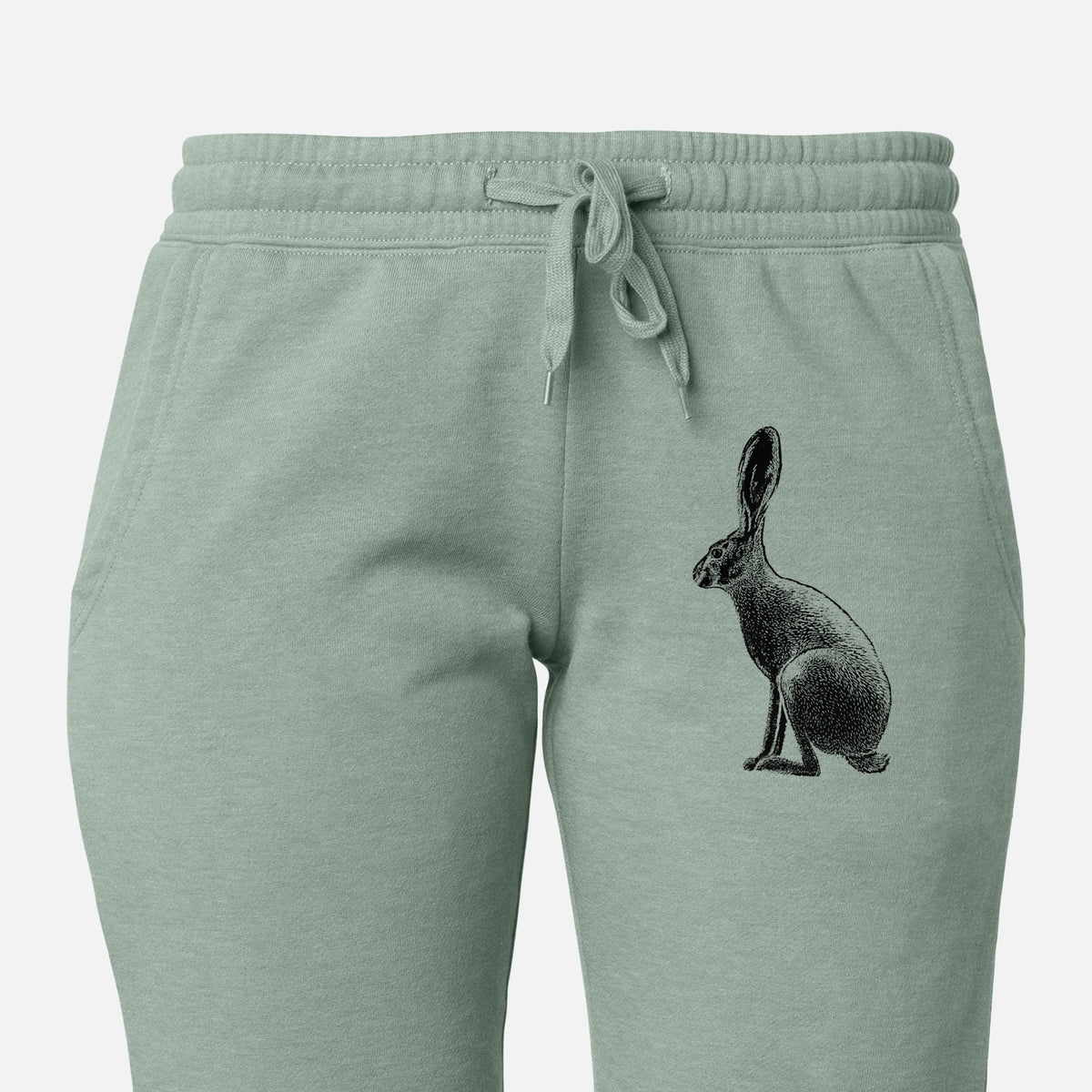 Front of sage green Cali Wave sweatpants, printed with a detailed black ink illustration of a black-tailed jackrabbit sitting in profile with tall ears on the leg.