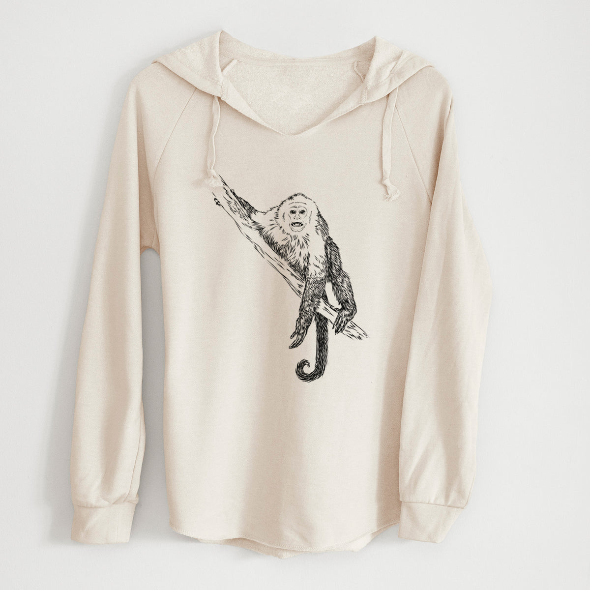 Bone cream women's Cali Wave hooded sweatshirt laid flat, printed with a detailed black ink illustration of a capuchin monkey climbing a branch.