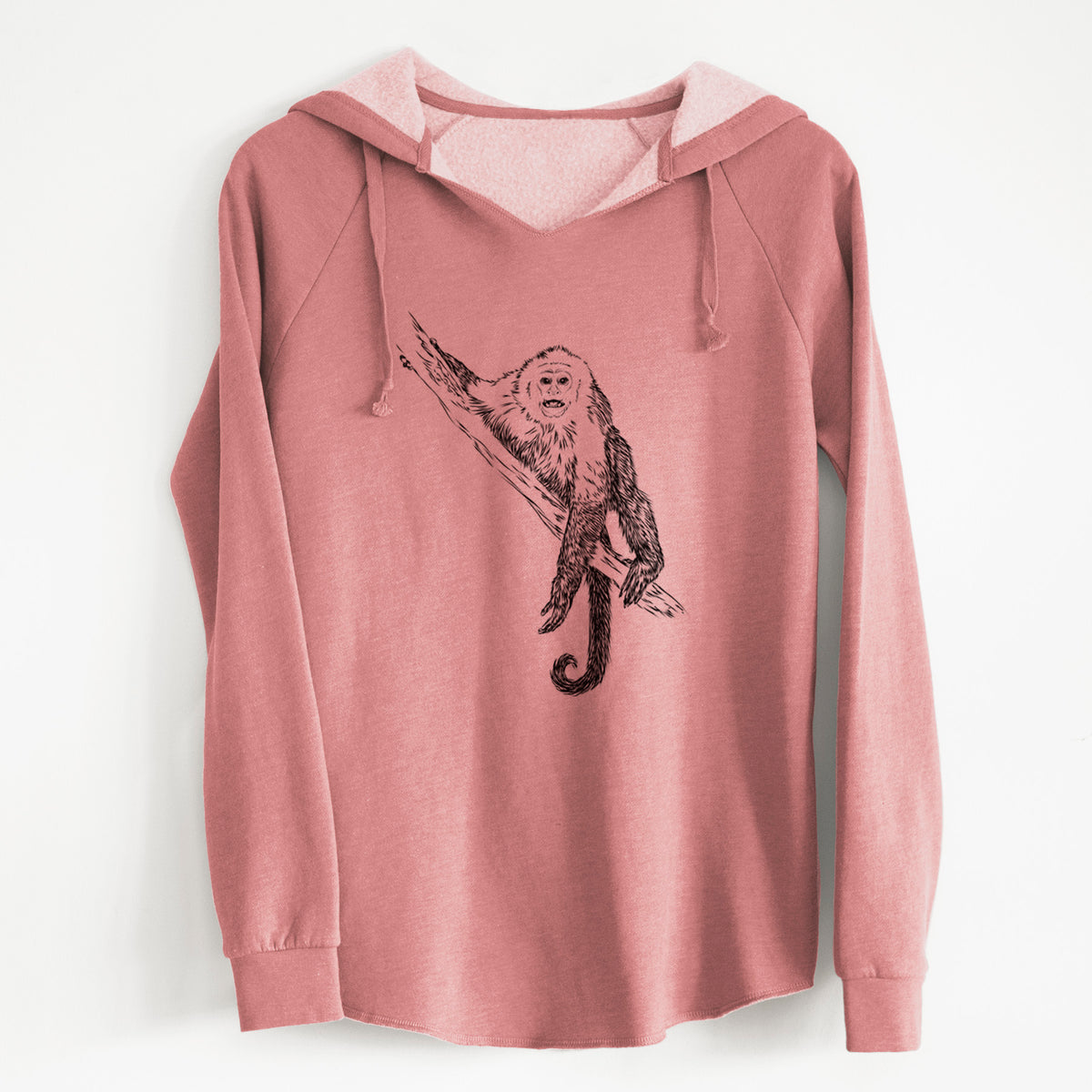 Dusty rose women's Cali Wave hooded sweatshirt laid flat, printed with a detailed black ink illustration of a capuchin monkey climbing a branch.