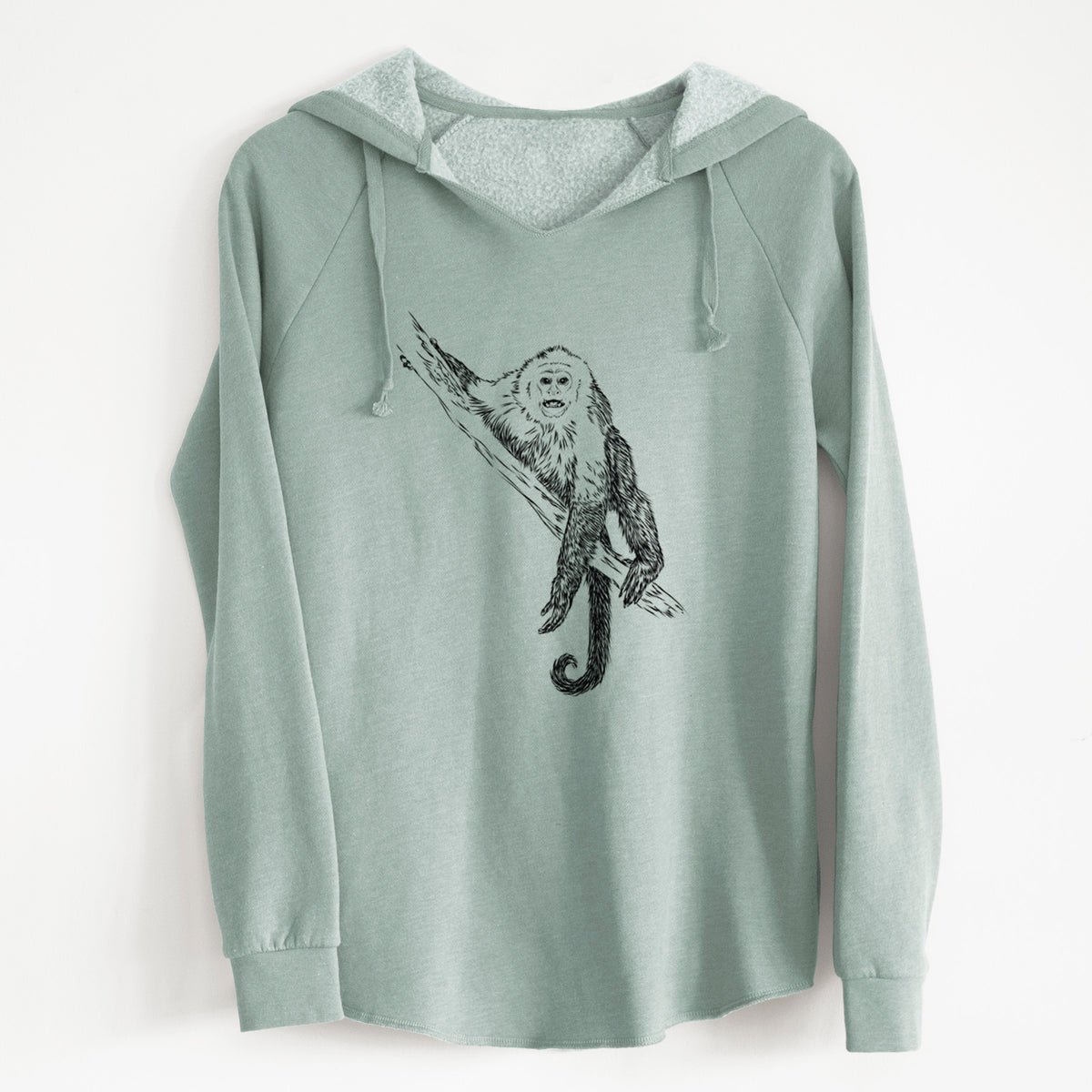 Sage green women's Cali Wave hooded sweatshirt laid flat, printed with a detailed black ink illustration of a capuchin monkey climbing a branch.