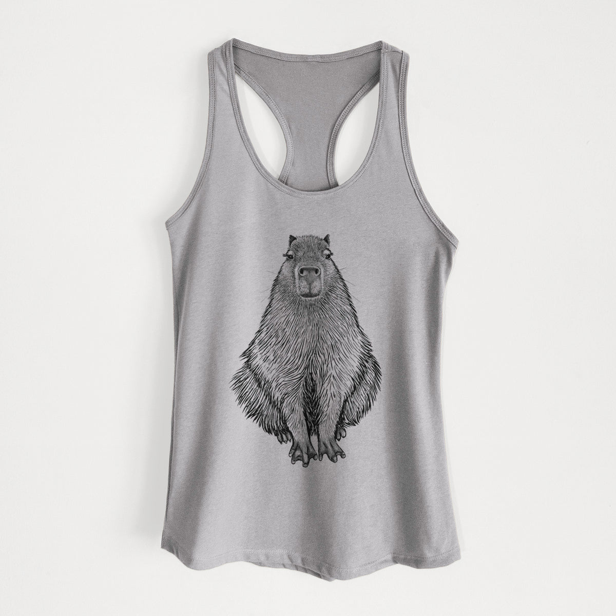 Heather grey women's racerback tank top laid flat, printed with a detailed black ink illustration of a capybara sitting and facing forward.