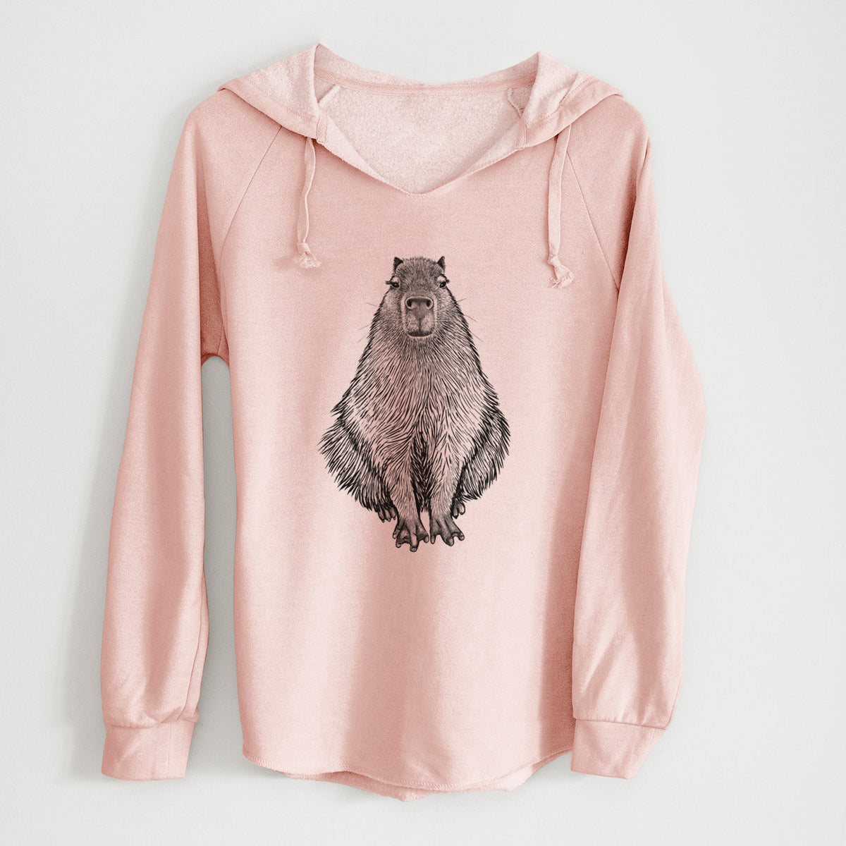 Blush pink women's Cali Wave hooded sweatshirt laid flat, printed with a detailed black ink illustration of a capybara sitting and facing forward.