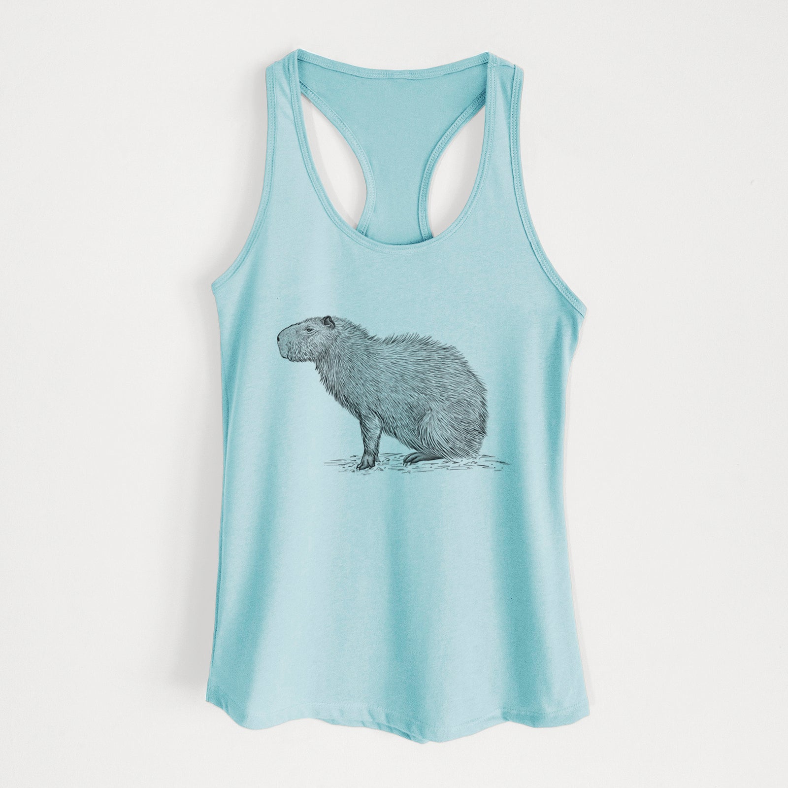 Banana cream women's racerback tank top laid flat, printed with a detailed black ink illustration of a capybara standing in profile.