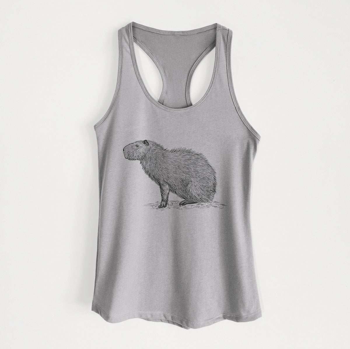 Heather grey women's racerback tank top laid flat, printed with a detailed black ink illustration of a capybara standing in profile.
