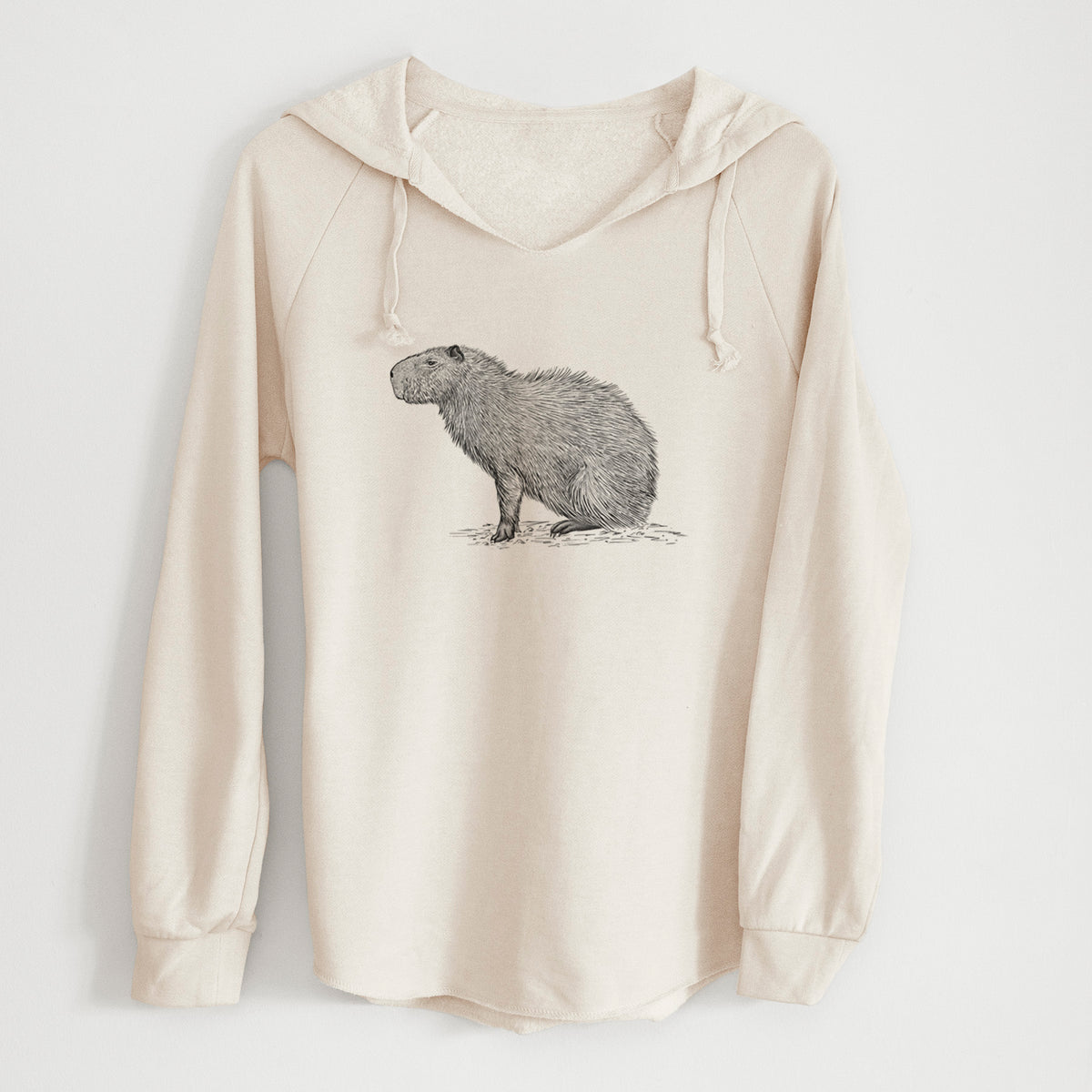 Bone cream women's Cali Wave hooded sweatshirt laid flat, printed with a detailed black ink illustration of a capybara standing in profile.