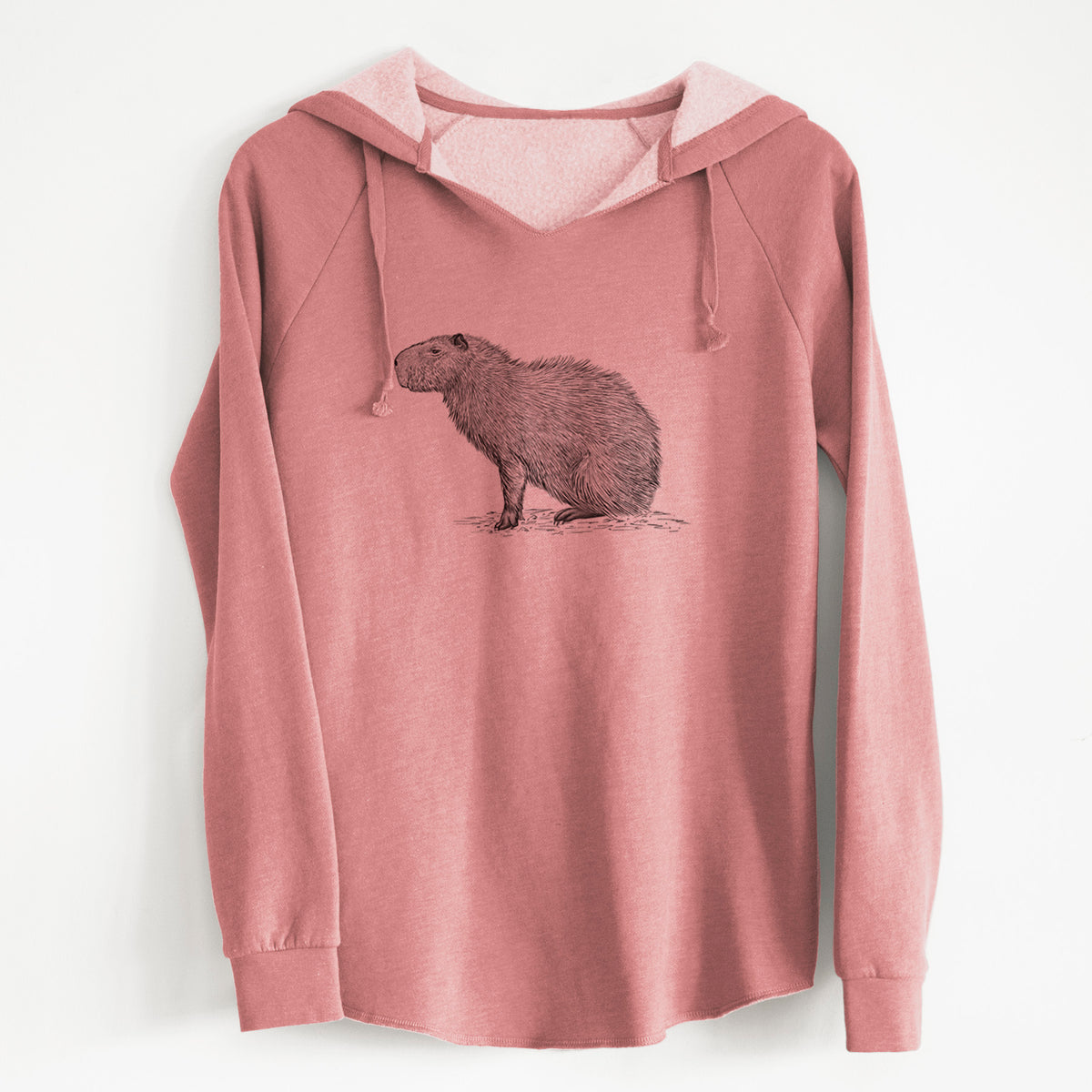 Dusty rose women's Cali Wave hooded sweatshirt laid flat, printed with a detailed black ink illustration of a capybara standing in profile.
