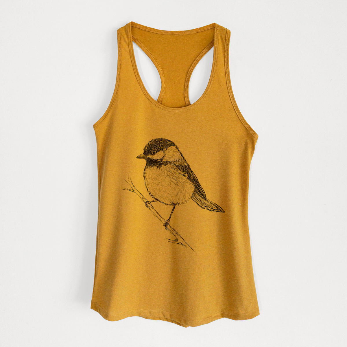Gold women's racerback tank top laid flat, printed with a detailed black ink sketch of a black-capped chickadee perched on a branch.