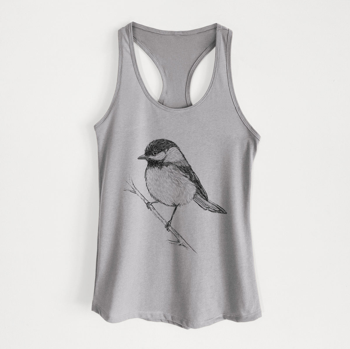 Heather grey women's racerback tank top laid flat, printed with a detailed black ink sketch of a black-capped chickadee perched on a branch.