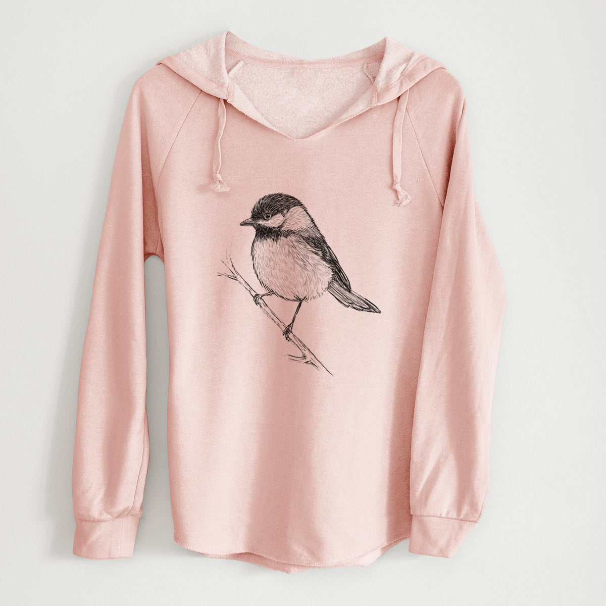 Blush pink women's Cali Wave hooded sweatshirt laid flat, printed with a detailed black ink sketch of a black-capped chickadee perched on a branch.