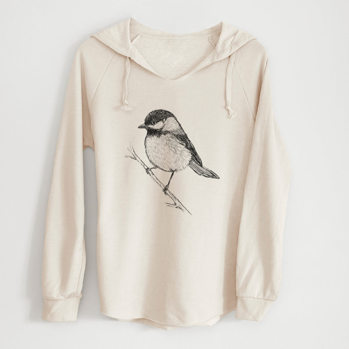 Bone cream women's Cali Wave hooded sweatshirt laid flat, printed with a detailed black ink sketch of a black-capped chickadee perched on a branch.
